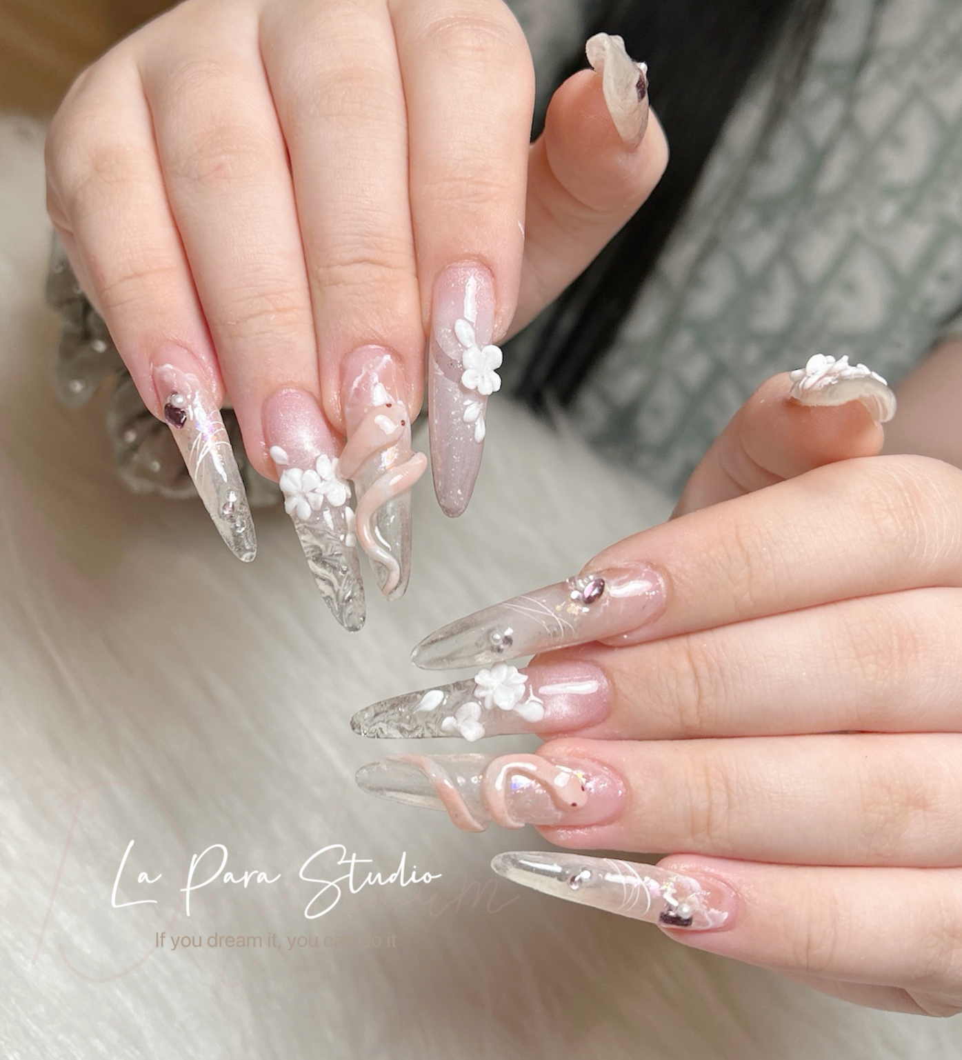 Clear and blush nail extensions with white three-dimensional flowers