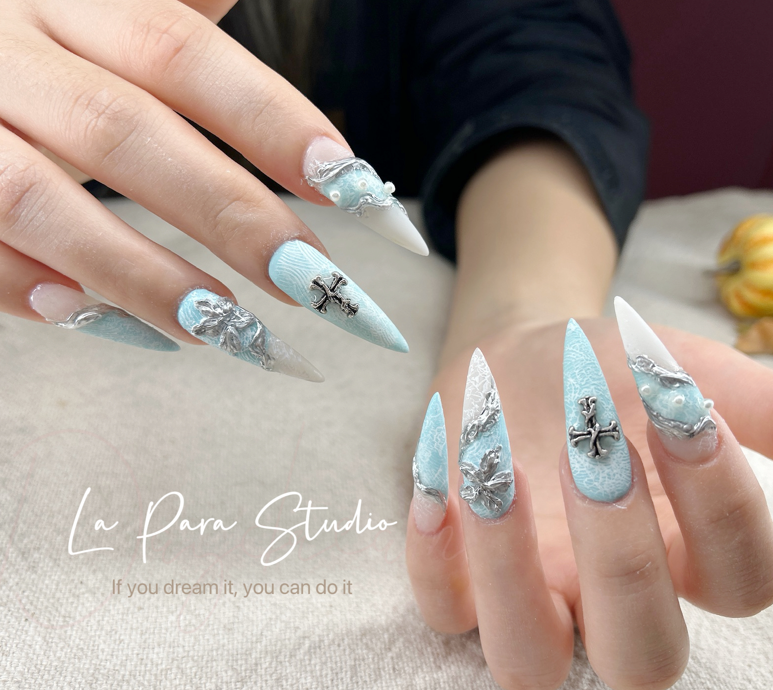 Blue and silver sculpted nail design with long almond extensions