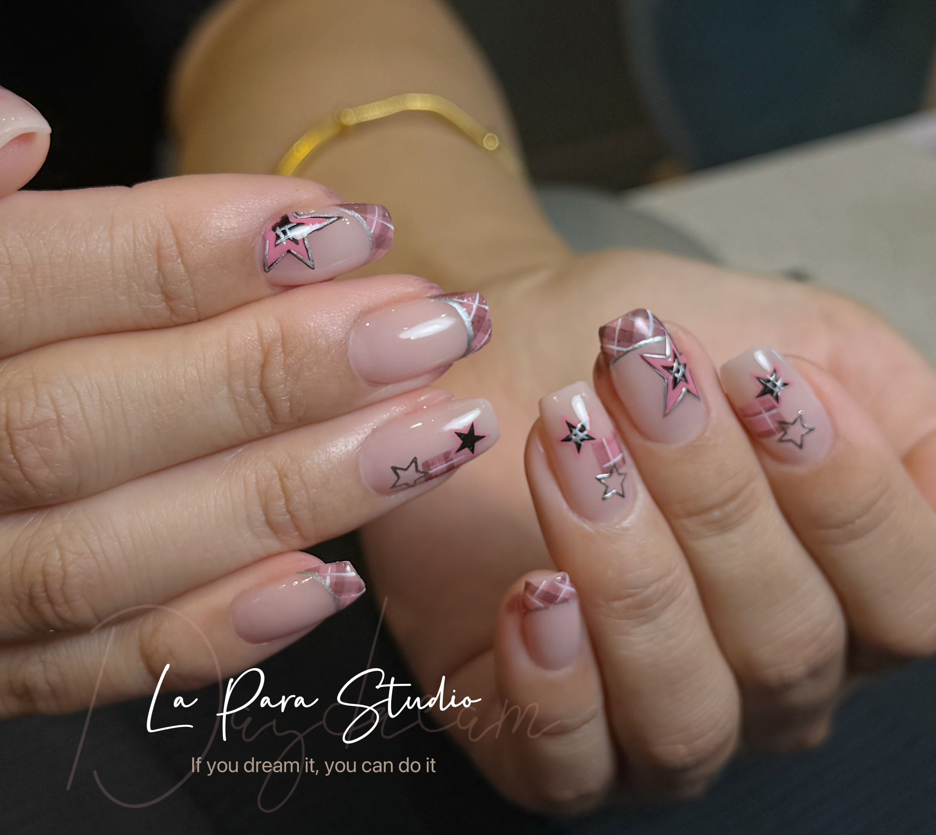 Pink star nail design with glossy square tips
